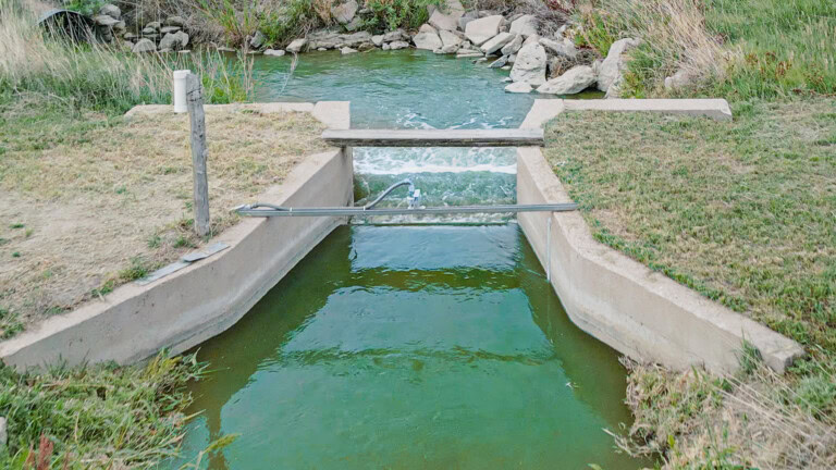 Downstream of the gates, OCF for flow rate and total